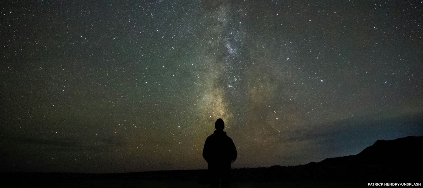 Person at night starring up at the Milky Way.